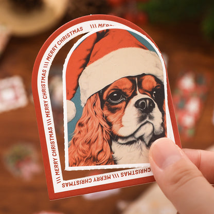 Card with a dog wearing a Santa hat and 'Merry Christmas' text, held by a hand.