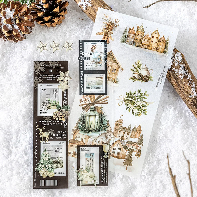 Decorative washi paper and P.E.T sheets from inside the sticker book paper with winter-themed designs on a snowy surface