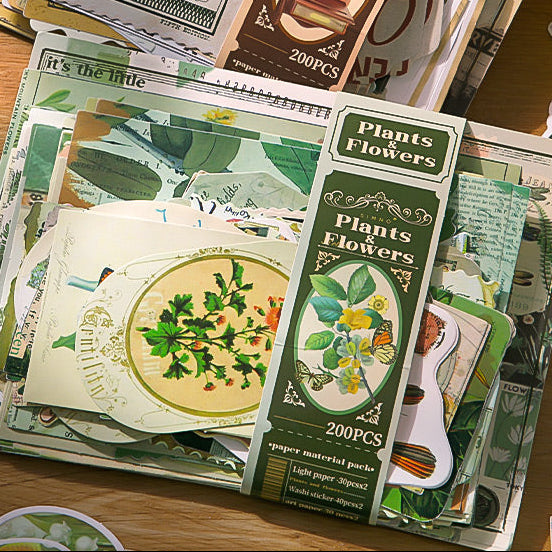 Collection of vintage-style flowers and plant journaling material and sticker pack  on a wooden surface