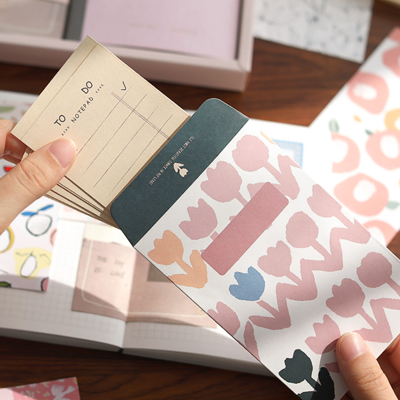 Floral  envelope  with notepapers being placed inside